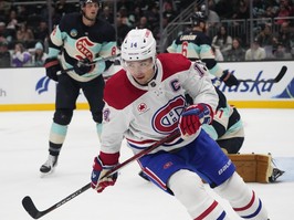 Canadiens centre Nick Suzuki (14) skates away after scoring against the Seattle Kraken on Sunday, March 24, 2024, in Seattle.