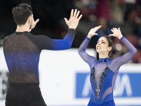 Deanna Stellato-Dudek and Maxime Deschamps of Canada react following their pairs short program for the 2024 ISU World Figure Skating Championships in Montreal, Wednesday, March 20, 2024.