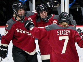 Montreal's Mélodie Daoust (25) celebrates with teammates Marie-Philip Poulin (29) and Laura Stacey (7) after scoring against Boston during PWHL hockey action in Montreal on March 2, 2024.