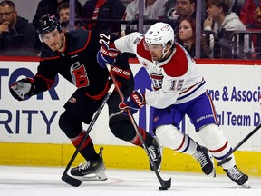 Canadiens' Alex Newhook skates with the puck, while Hurricanes' Brett Pesce trails the play during second-period action in Raleigh, N.C., Thursday night.
