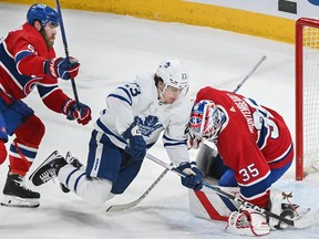 Toronto Maple Leafs' Matthew Knies (23) moves in on Canadiens goaltender Sam Montembeault as Canadiens' David Savard defends during first period NHL hockey action in Montreal on Saturday, March 9, 2024.