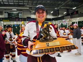 Stingers forward Emmy Fecteau holds the Golden Path Trophy after Concordia beat the University of Toronto Varsity Blues 3-1 at USports University Cup final in Saskatoon on Sunday night.