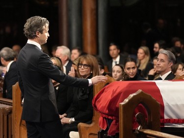 Nicolas Mulroney approaches to touch the casket of his father, former prime minister Brian Mulroney, during his funeral in Montreal, Saturday, March 23, 2024.