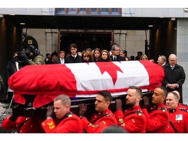 Immediate family look on as RCMP pallbearers carry the casket to a hearse at the end of the funeral of former prime minister Brian Mulroney, in Montreal, Saturday, March 23, 2024.