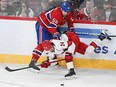Canadiens' David Savard (58) checks Carolina Hurricanes' Seth Jarvis (24) during first period NHL hockey action in Montreal on Saturday, March 30, 2024.
