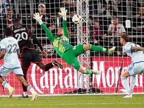 D.C. United's Christian Benteke (20) takes a shot against CF Montréal goalie Jonathan Sirois during the first half of an MLS soccer match at Audi Field on Saturday, March 30, 2024, in Washington.