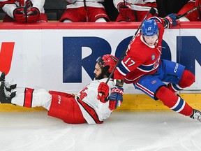 Canadiens' Josh Anderson (17) collides with Carolina Hurricanes' Jalen Chatfield in Montreal on Saturday, March 30, 2024.