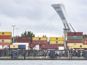 A federal tribunal says Montreal port employers have no right to make employees work during a strike, paving the way for negotiations to resume ahead of potential job action. Trucks carrying shipping containers drive through the Port of Montreal, Tuesday, Sept.19, 2023.