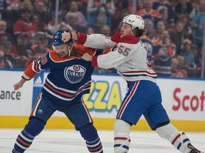 The Canadiens' Michael Pezzetta landing a blow to the head of the Oilers' Sam Carrick during a game in Edmonton.
