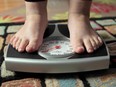 Photo shows feet on a scale, taken from the film documentary Fed Up.