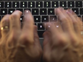 A man uses a computer keyboard in Toronto in this Sunday, Oct. 9 photo illustration.