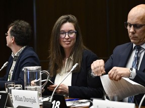 Environmental Defence Canada's Cassie Barker, centre, concludes an appearance at the Standing Committee on Environment and Sustainable Development in Ottawa, on Thursday, March 21, 2024.