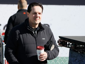 Daniel Brière walks outside holding a drink cup