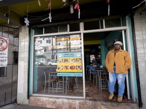 Vivianne Petit Frere, of Haiti, stands in the doorway of the Haitian restaurant she runs Wednesday, March 13, 2024, in downtown Tijuana, Mexico.