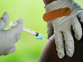 A health worker administers a dose of COVID-19 vaccine during a vaccination clinic in Reading, Pa. on Friday, Oct. 7, 2022.