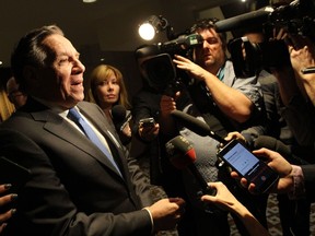 Francois Legault surrounded by press