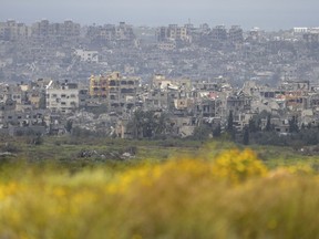 Destroyed buildings stand in the Gaza Strip as seen from southern Israel, Monday, March 18, 2024.