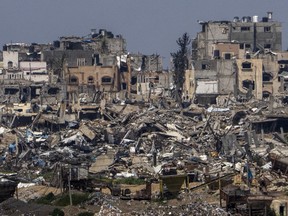 Destroyed buildings stand inside Gaza Strip, as seen from southern Israel, Tuesday, March 19, 2024.