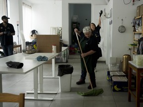 Christian volunteers Elisabeth Odegaard, rear right, Claudio Rafael, left, and Jannie Slim, centre, clean up after preparing food for Israeli soldiers on a brief respite from combat operations in the Gaza Strip, in Tel Aviv, Wednesday, March 6, 2024.