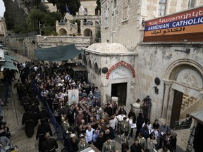 Christians walk the Way of the Cross procession that commemorates Jesus Christ's crucifixion on Good Friday, in the Old City of Jerusalem, Friday, March 29, 2024.
