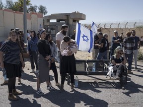 People gather at Israel's Nitzana border crossing with Egypt in southern Israel, Tuesday, March 5, 2024, protesting against the delivery of humanitarian aid to the Gaza Strip until all hostages held by Hamas militants are released.