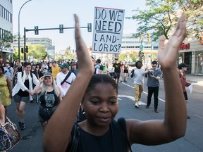 A woman claps her hands during a march in the street
