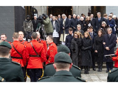 Mila Mulroney and her daughter Caroline Mulroney watch as the casket of Canada's 18th prime minister, Brian Mulroney, is taken away at Notre-Dame Basilica Saturday, March 23, 2024.