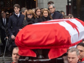 Mila Mulroney and her daughter Caroline watch as the casket of Canada's 18th prime minister, Brian Mulroney, is taken away at Notre-Dame Basilica on Saturday, March 23, 2024.
