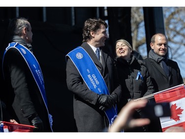 Canadian minister of Foreign Affairs, Mélanie Joly shares a laugh with Prime Minister Justin Trudeau on the reviewing stand during the Greek Independence Day Parade on Sunday, March 24, 2024. On the left is Greek Prime Minister Kyriakos Mitsotakis.