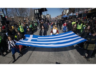 People take part in the Greek Independence Day Parade on Sunday, March 24, 2024, in Montreal.