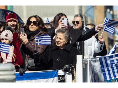 People take part in the Greek Independence Day Parade on Sunday, March 24, 2024, in Montreal.