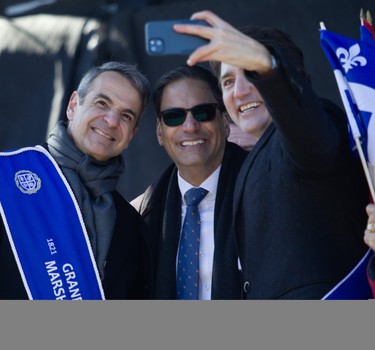 Prime Minister Justin Trudeau takes a selfie with former Quebec politician Gerry Sklavounos (centre) and Greek Prime Minister Kyriakos Mitsotakis during the 2024 Greek Independence Day Parade on Sunday, March 24, 2024.