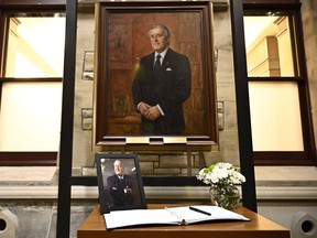 A photograph and book of condolences for Members of Parliament to sign are seen in front of the official portrait of former prime minister Brian Mulroney, in the antechamber to the House of Commons on Parliament Hill, Ottawa, Friday, March 1, 2024.