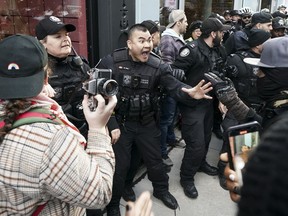 Police clash with protesters outside a Prime Minister Justin Trudeau in Toronto on Friday, March 15, 2024.