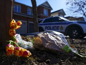 Flowers sit at the scene of a homicide where six people were found dead in the Barrhaven suburb of Ottawa on March 7.