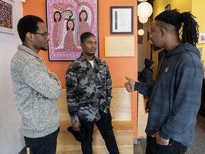 France Nelson Gideon, left, Wedne Colin and Hakeem Formonvil, right, employees at the Maison d'Haiti in Montreal, talk about the situation in Haiti, Monday, March 11, 2024.