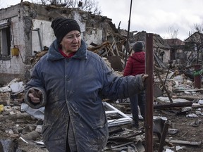 Inna, 71, stands outside of her house, which was destroyed by a Russian drone attack in a residential neighbourhood, in Zaporizhzhia, Ukraine, on Thursday, March 28, 2024.