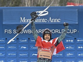 Eliot Grondin of Ste-Marie celebrates his victory in the men's finals at the FIS snowboard cross world cup event at Mont-Ste-Anne resort in Beaupre on Saturday, March 25, 2023. Grondin won silver at a World Cup snowboard cross competition in Spain on Saturday, March 2, 2024.