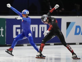 Montreal's William Dandjinou, right, pushes his skate over the finish line to win the final of the men's 1000m ahead of Italy's Pietro Sighel, left, at the World Championships Short Track skating at Ahoy Arena in Rotterdam, Netherlands, on Sunday, March 17, 2024.
