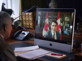 Britain's King Charles III speaks to Canadian Prime Minister Justin Trudeau via videolink during a virtual audience, at Buckingham Palace, in London, Wednesday, March 6, 2024.