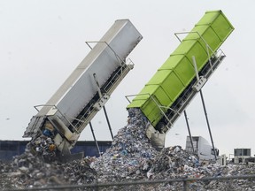 Garbage is loaded into a landfill in Lenox Township, Mich., July 28, 2022.
