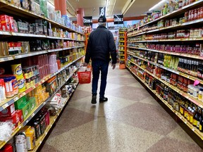 Photo shows unidentified shopper in a grocery store aisle.