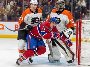 Canadiens' Brendan Gallagher is knocked to the ice by Flyers' Ronnie Attard in front of goalie Samuel Ersson during game last week in the Bell Centre.