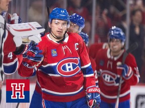 Nick Suzuki high-fives players on the Montreal Canadiens bench as he skates by