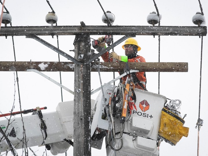 Hydro-Québec workers re-establish  power at the corner of Jean-Talon St. and St-Michel Blvd. on Thursday April 4, 2024 following a spring snowstorm that hit the city overnight.