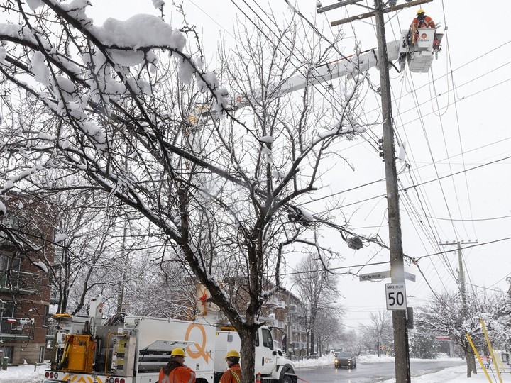 Hydro-Québec workers re-establish  power at the corner of Jean-Talon St. and St-Michel Blvd. on Thursday April 4, 2024 following a spring snowstorm that hit the city overnight.