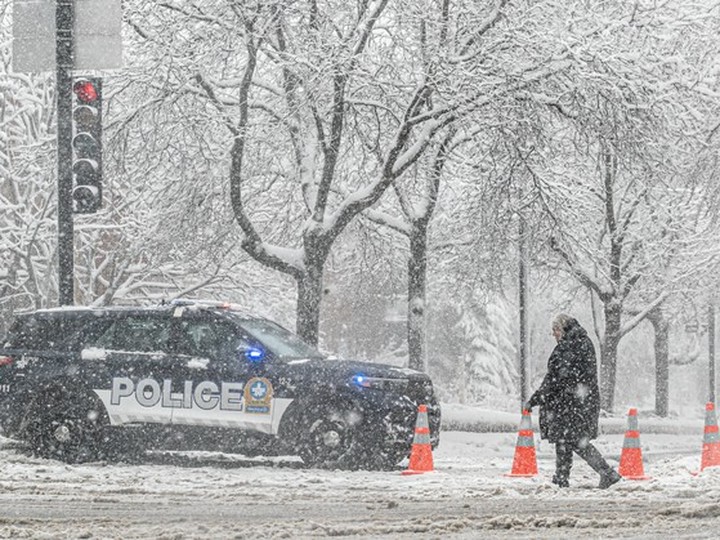 Police blocked access to the southbound lane on Atwater Ave. because of heavy snow weighing down a tree farther down the road April 4, 2024. 