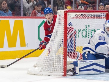 Montreal Canadiens' Cole Caufield circles behind Tampa Bay Lightning goalie Matt Tomkins