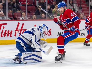 Montreal Canadiens' Joel Armia looks at the puck next to the Tampa goaltender's pad