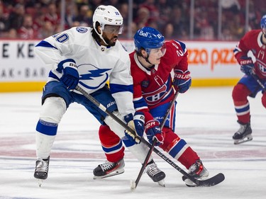 Montreal Canadiens' Cole Caufield bumps against Tampa Bay Lightning's Anthony Duclair